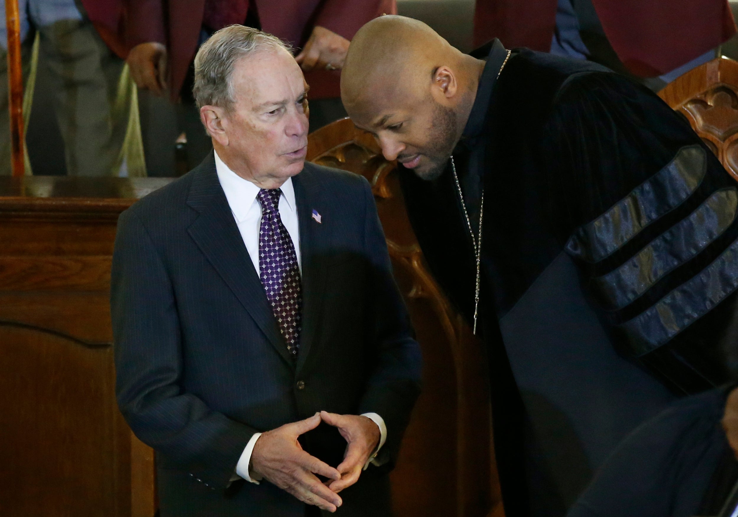 Mike Bloomberg speaks to the Rev Robert Turner at the Vernon American Methodist Episcopal Church in Tulsa, Oklahoma