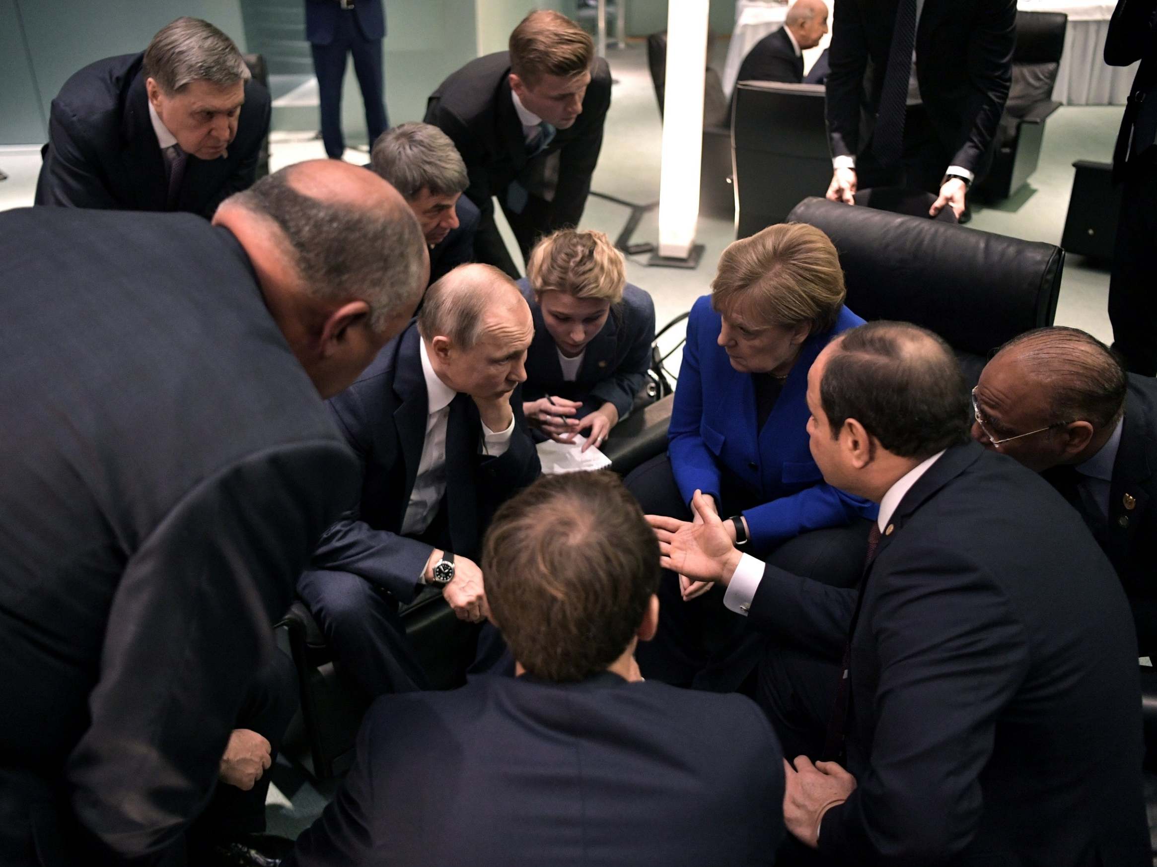 Vladimir Putin, Angela Merkel and Egypt's Abdul Fattah al-Sisi talk on the sidelines of Sunday's summit in Berlin