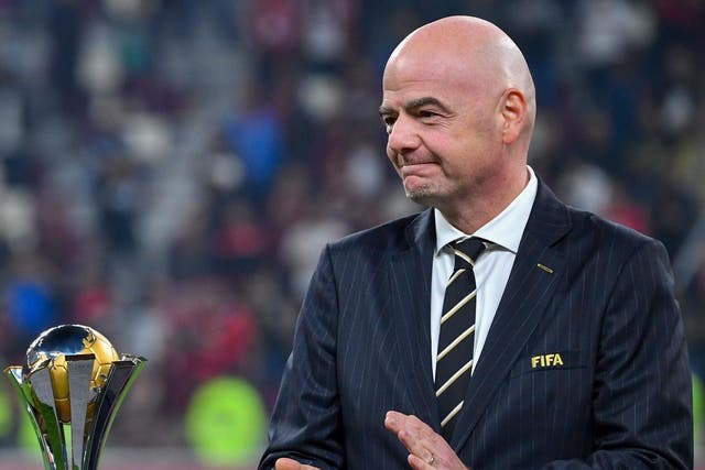 Fifa president Gianni Infantino presents the Club World Cup trophy