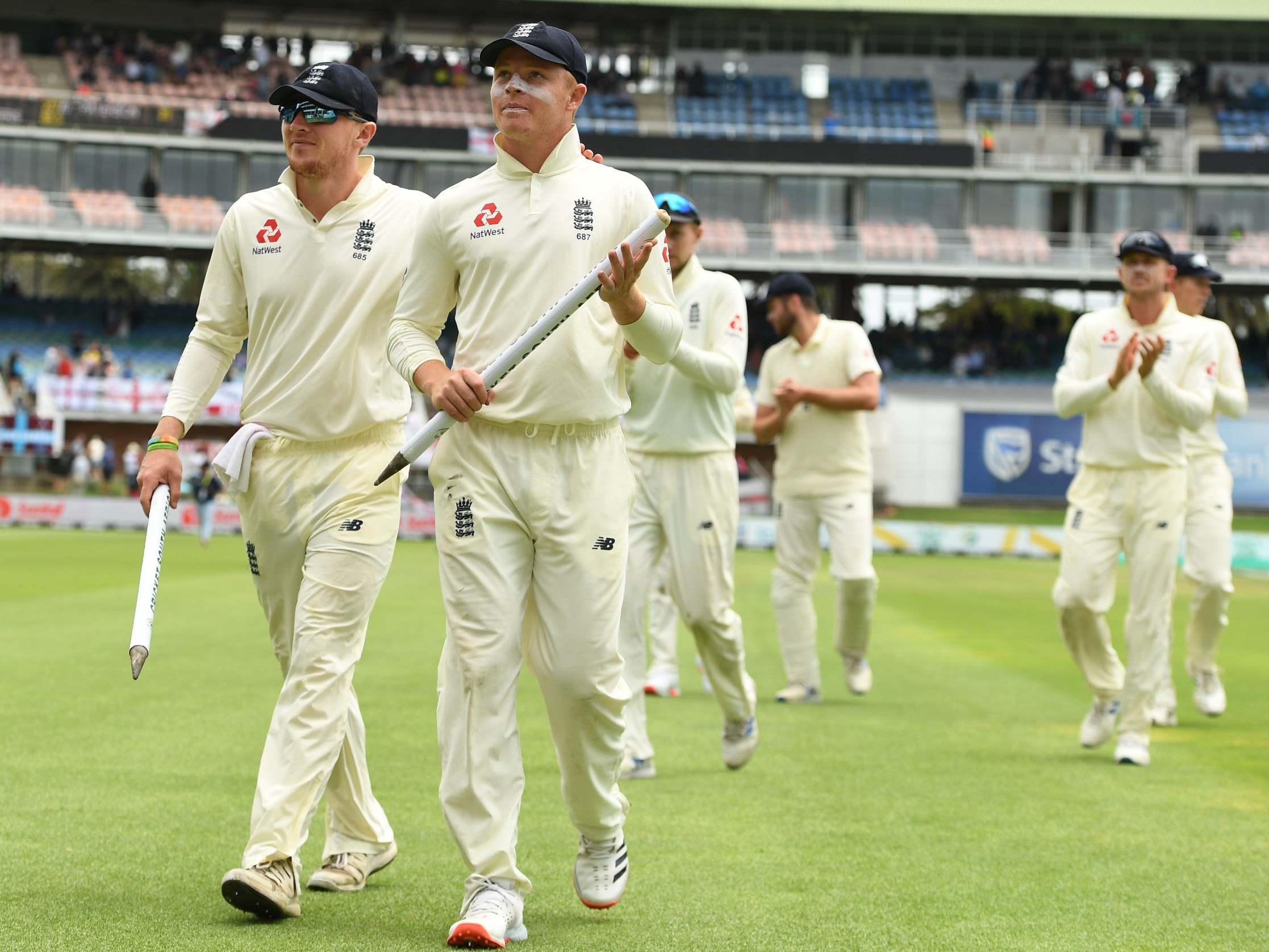 Dom Bess and Ollie Pope lead England off the field after victory in the third Test