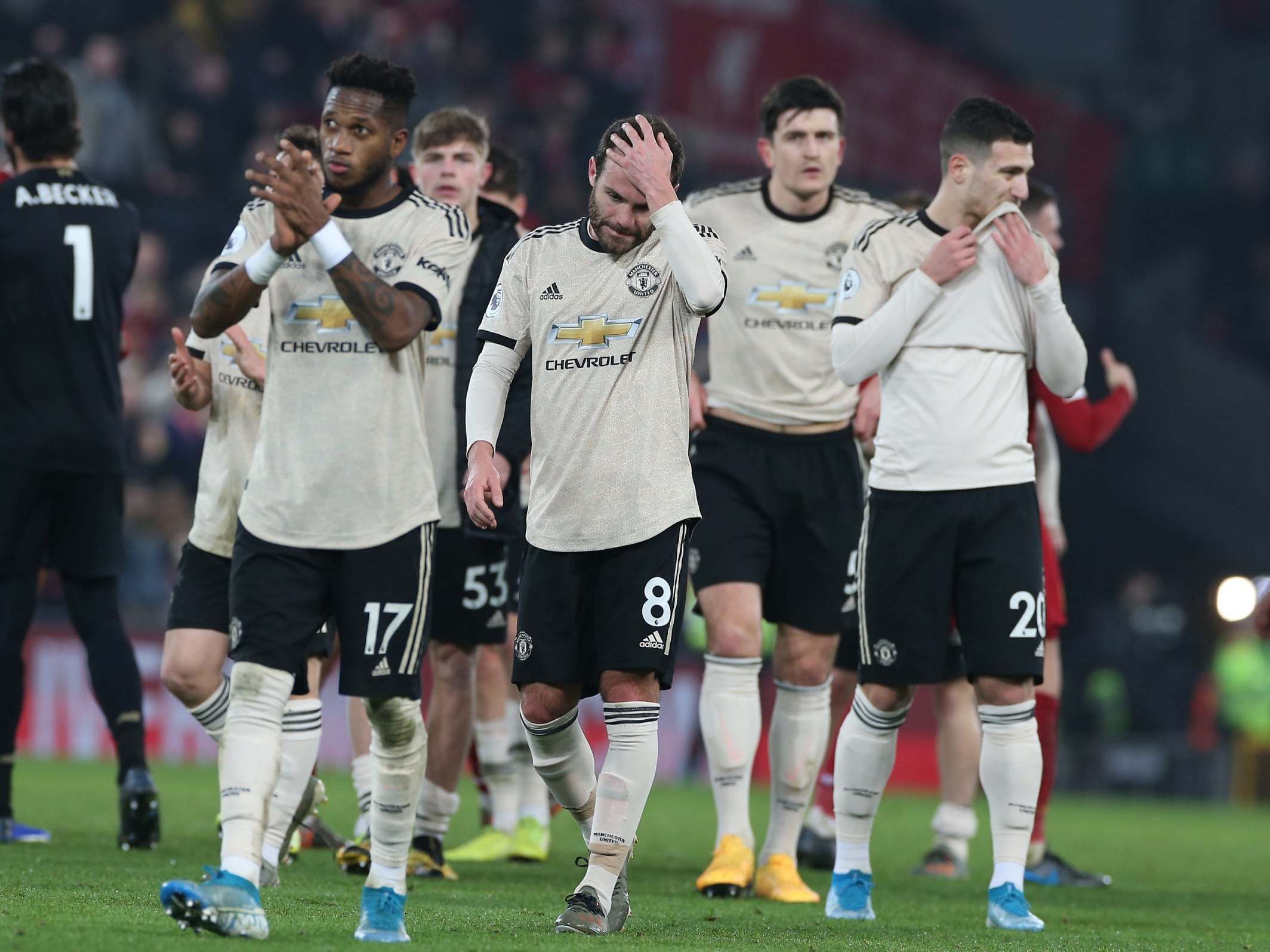 Man United players applaud the away supporters at Anfield