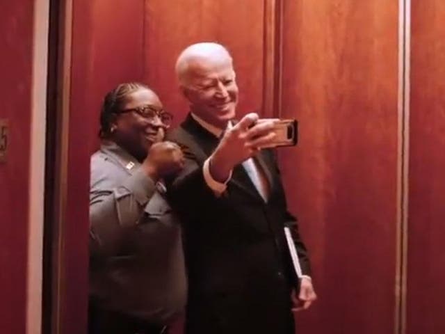 Joe Biden takes a selfie with an elevator operator on his way to a meeting with The New York Times' editorial board