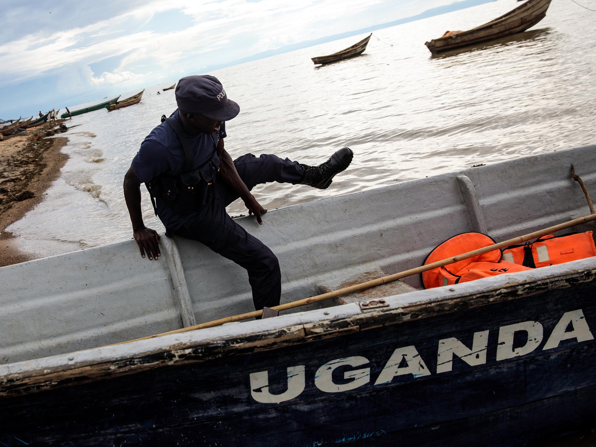 Ugandan police watch the border with DRC across Lake Albert