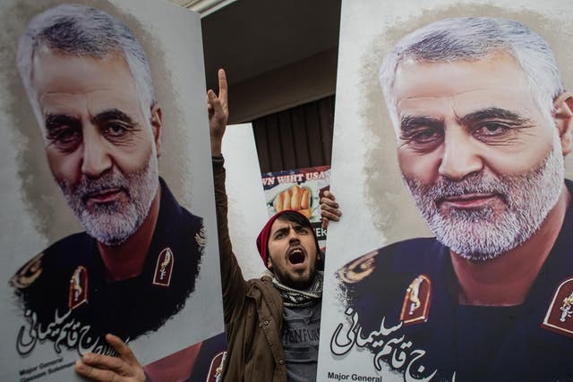 Mourners in Iran hold pictures of Maj. Gen. Qasem Soleimani, who was killed by US military forces in Iraq. Getty
