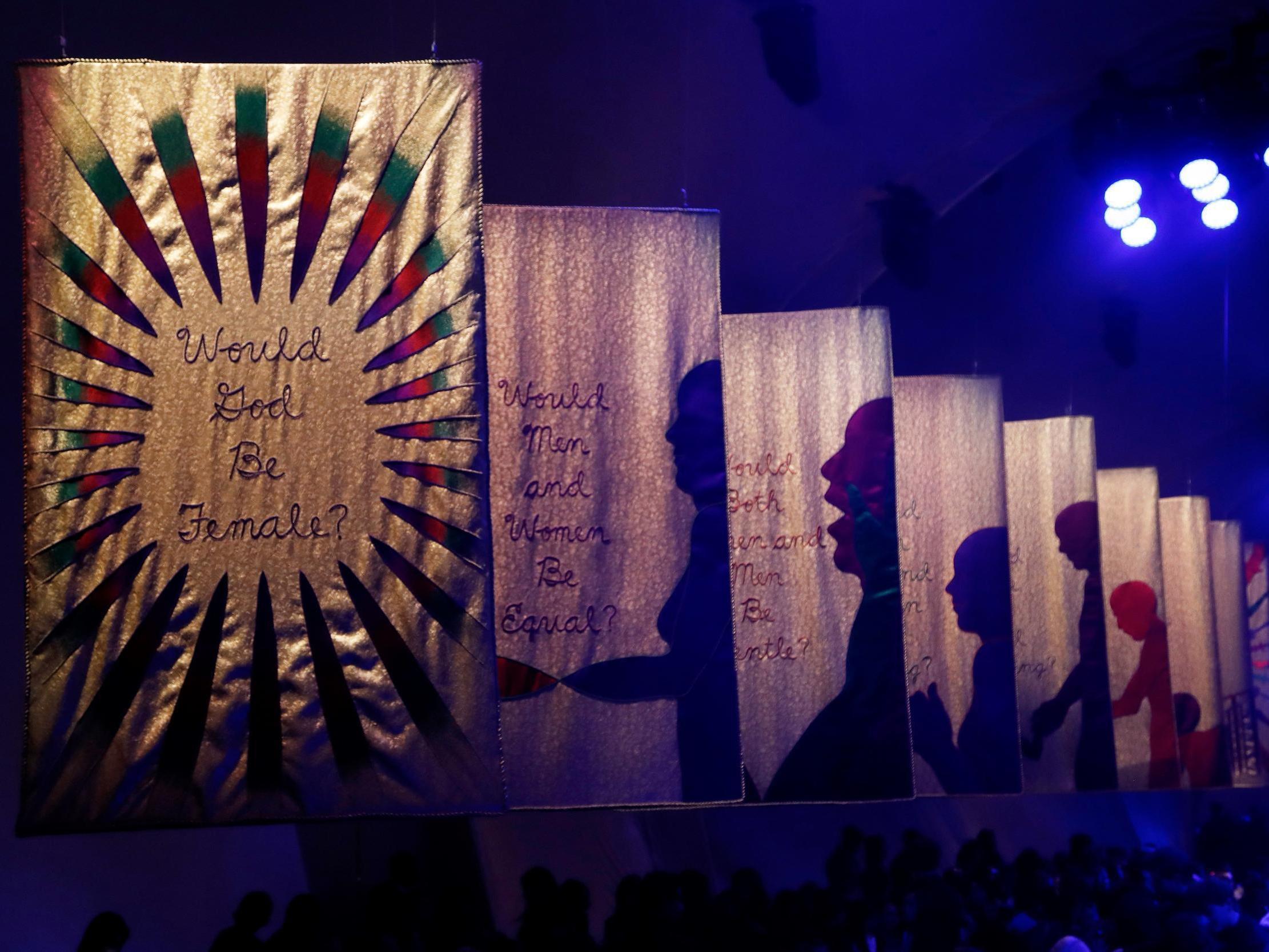 The runway was lined with banners asking what the world would look like if it was run by women (Getty)