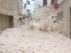 Spanish town submerged in sea foam as tidal surge sweeps miles inland