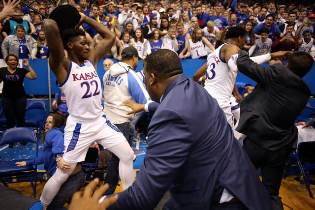 Players from the Kansas State Wildcats and the Kansas Jayhawks brawl during a game at the Allen Fieldhouse in Lawrence, Kansas