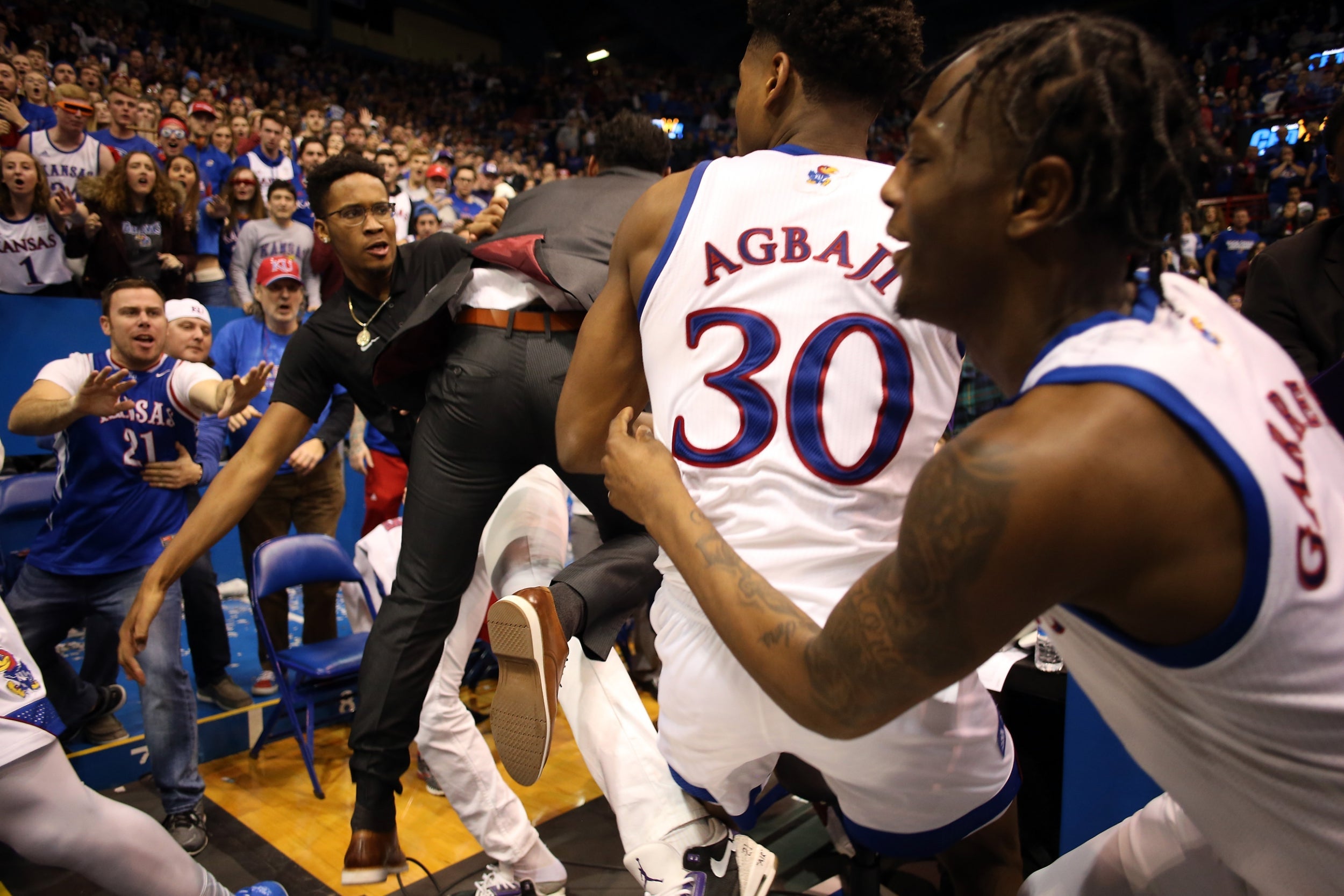 Players from the Kansas State Wildcats and the Kansas Jayhawks brawl during a game at the Allen Fieldhouse in Lawrence, Kansas