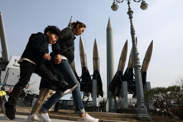 South Koreans walk past replicas of a North Korean Scud-B missile (C, back) and South Korean Nike missile (front) at the Korean War Memorial on February 28, 2019 in Seoul, South Korea