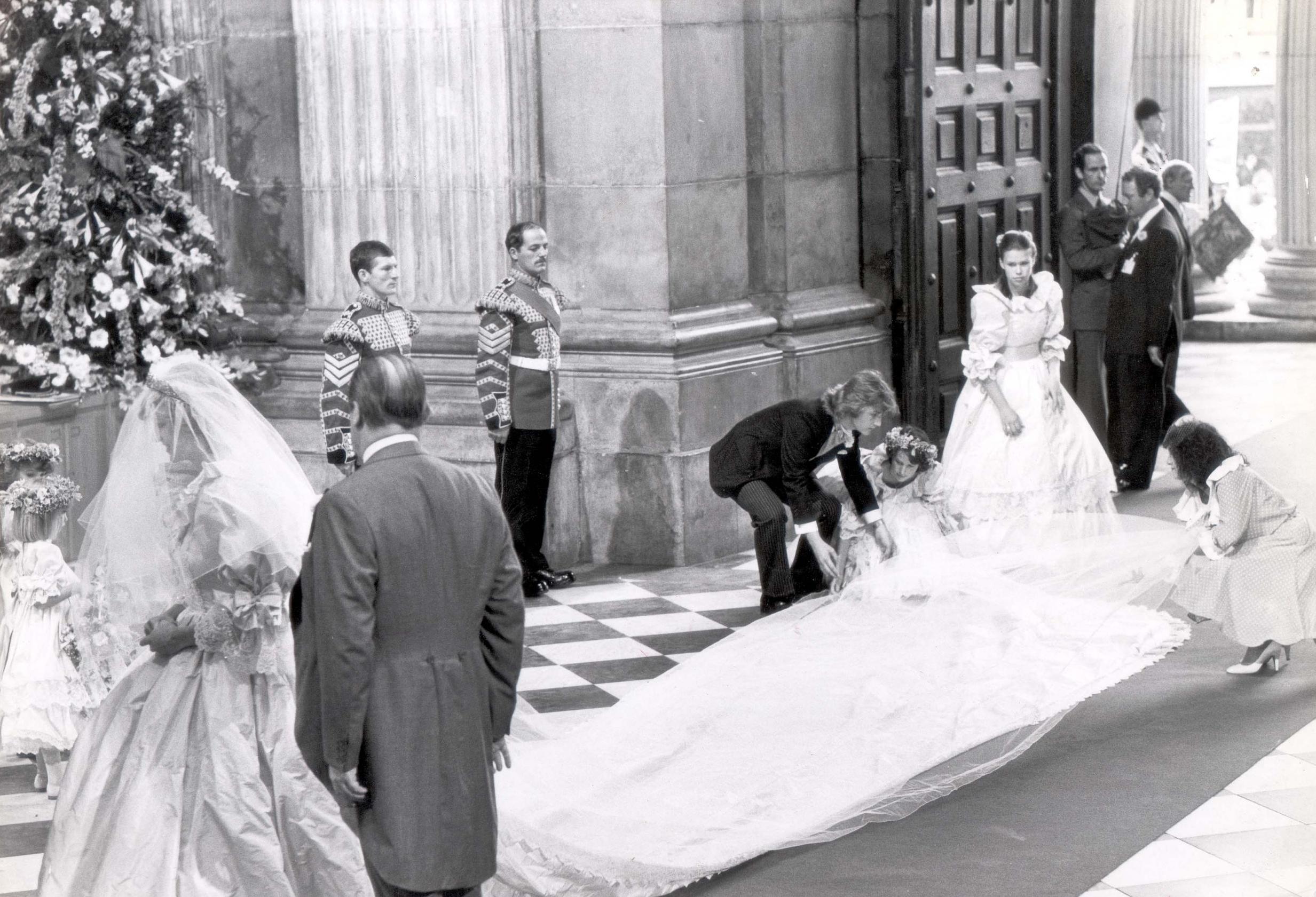 Bridesmaid India Hicks helps to unfold Princess Diana’s bridal train on the day of her wedding to Prince Charles