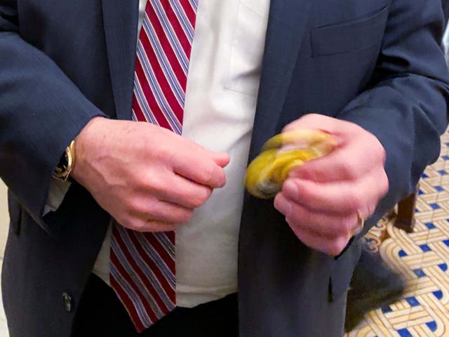 Senator Mike Rounds plays with a fidget spinner handed out to Republicans during the impeachment trial