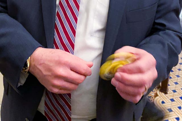 Senator Mike Rounds plays with a fidget spinner handed out to Republicans during the impeachment trial