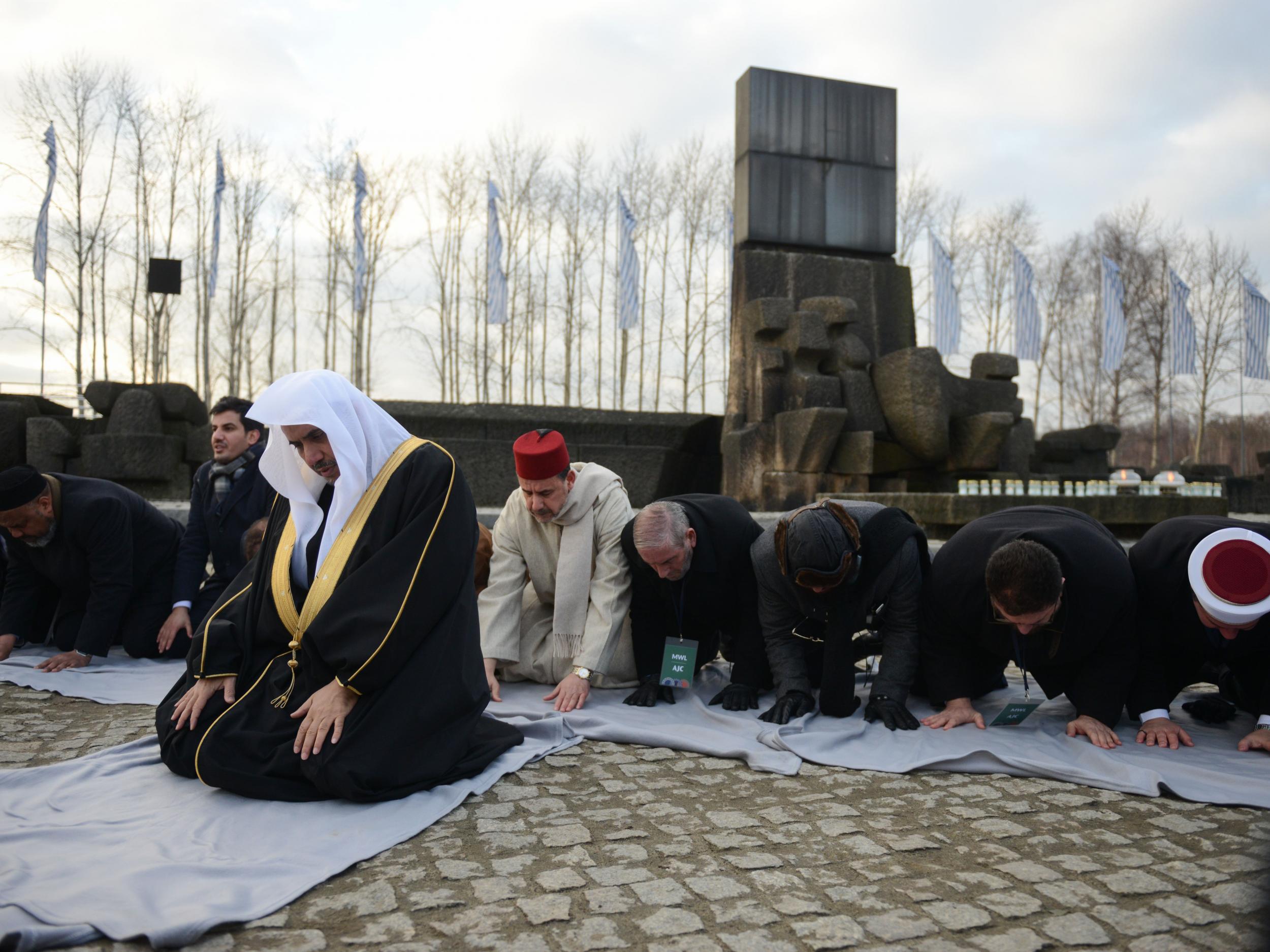 Muslim faith leaders perform Islamic prayers during a visit to Auschwitz