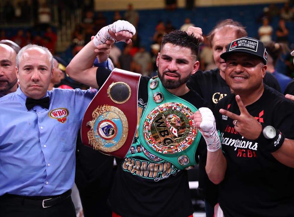 Jose Ramirez celebrates defeating Maurice Hooker to win the WBC and WBO titles
