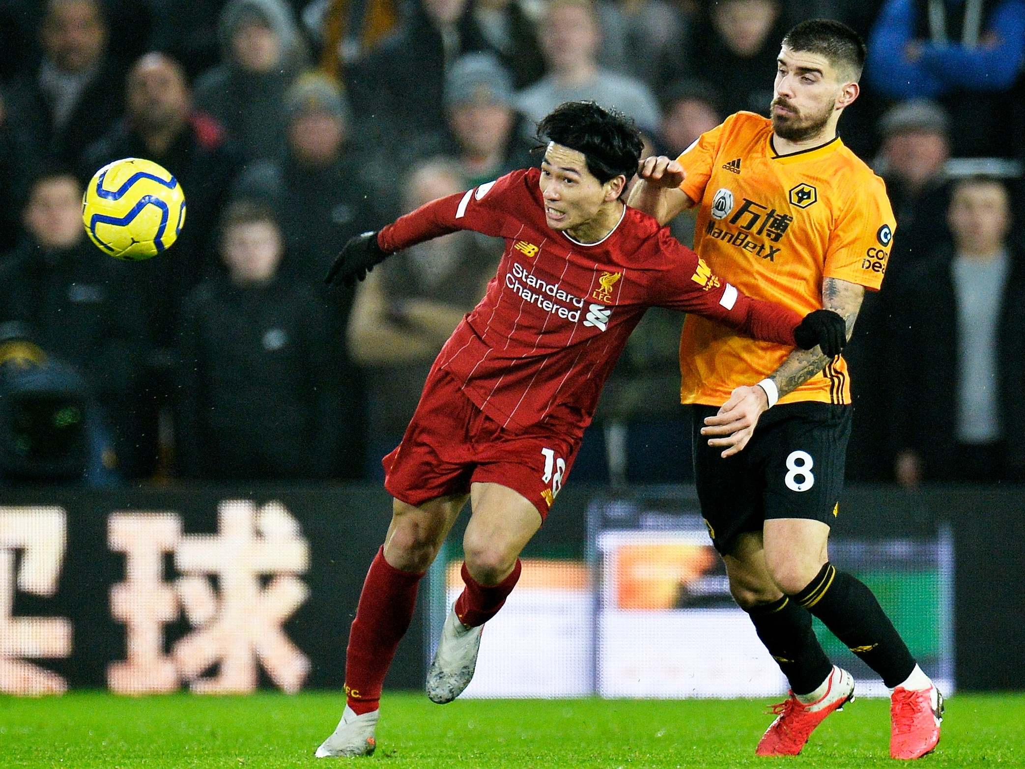 Liverpool's Takumi Minamino in action against Wolverhampton Wanderers' Ruben Neves