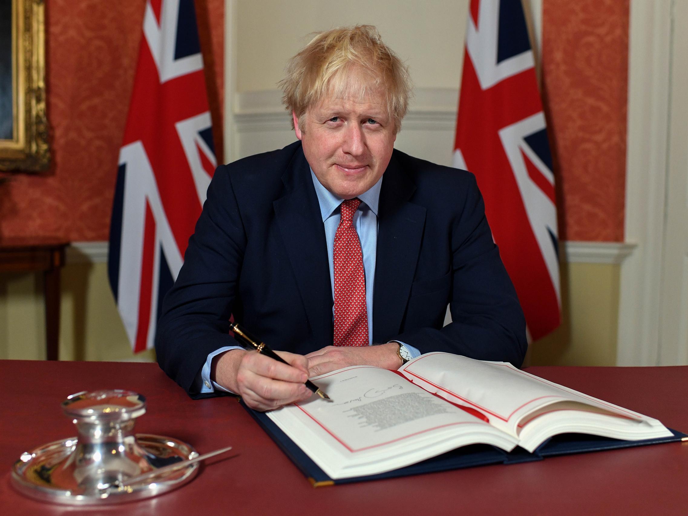 Boris Johnson signing the withdrawal agreement which will take the UK out of the EU