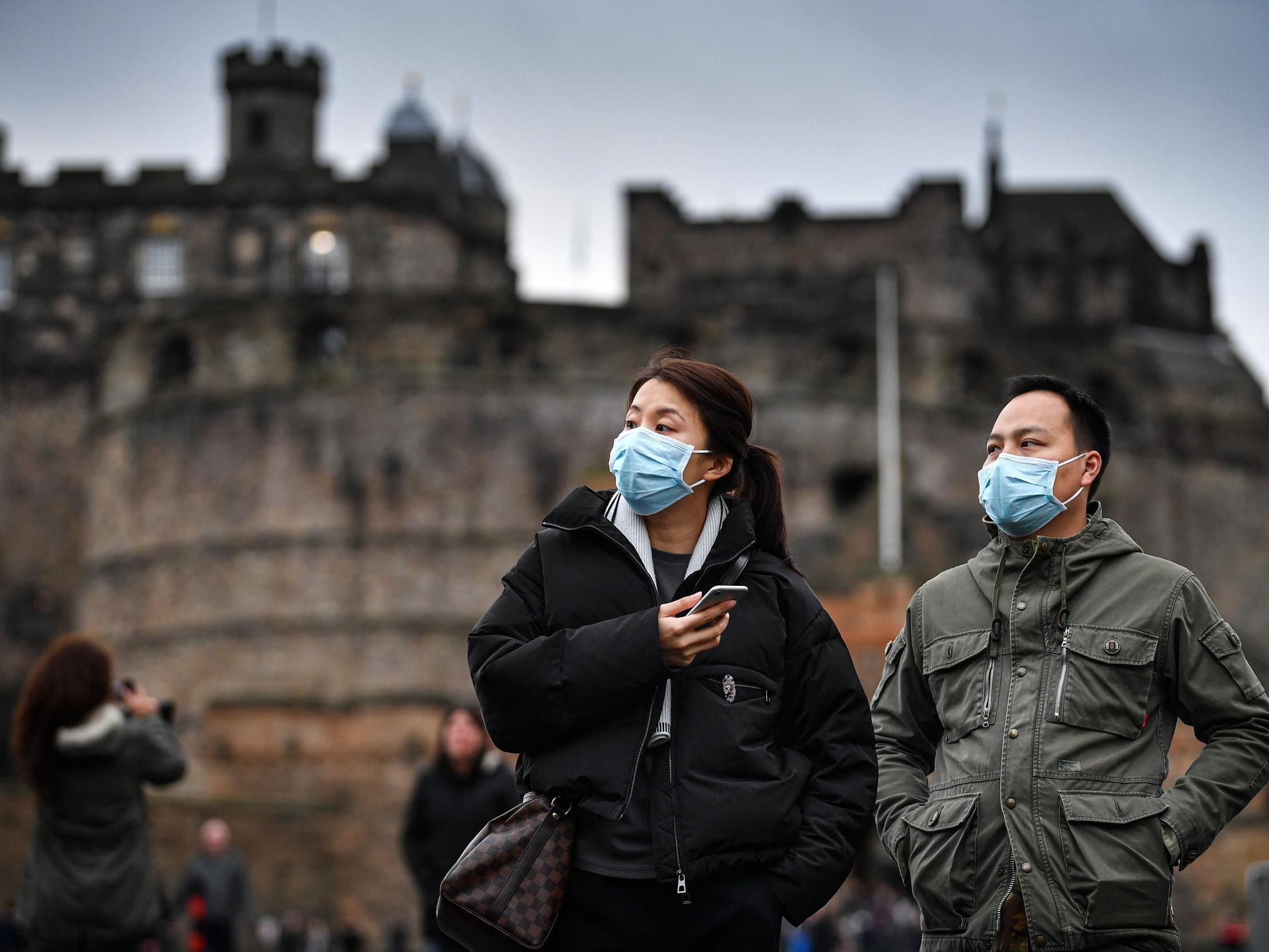 Tourists wear face masks as they visit Edinburgh Castle on Friday