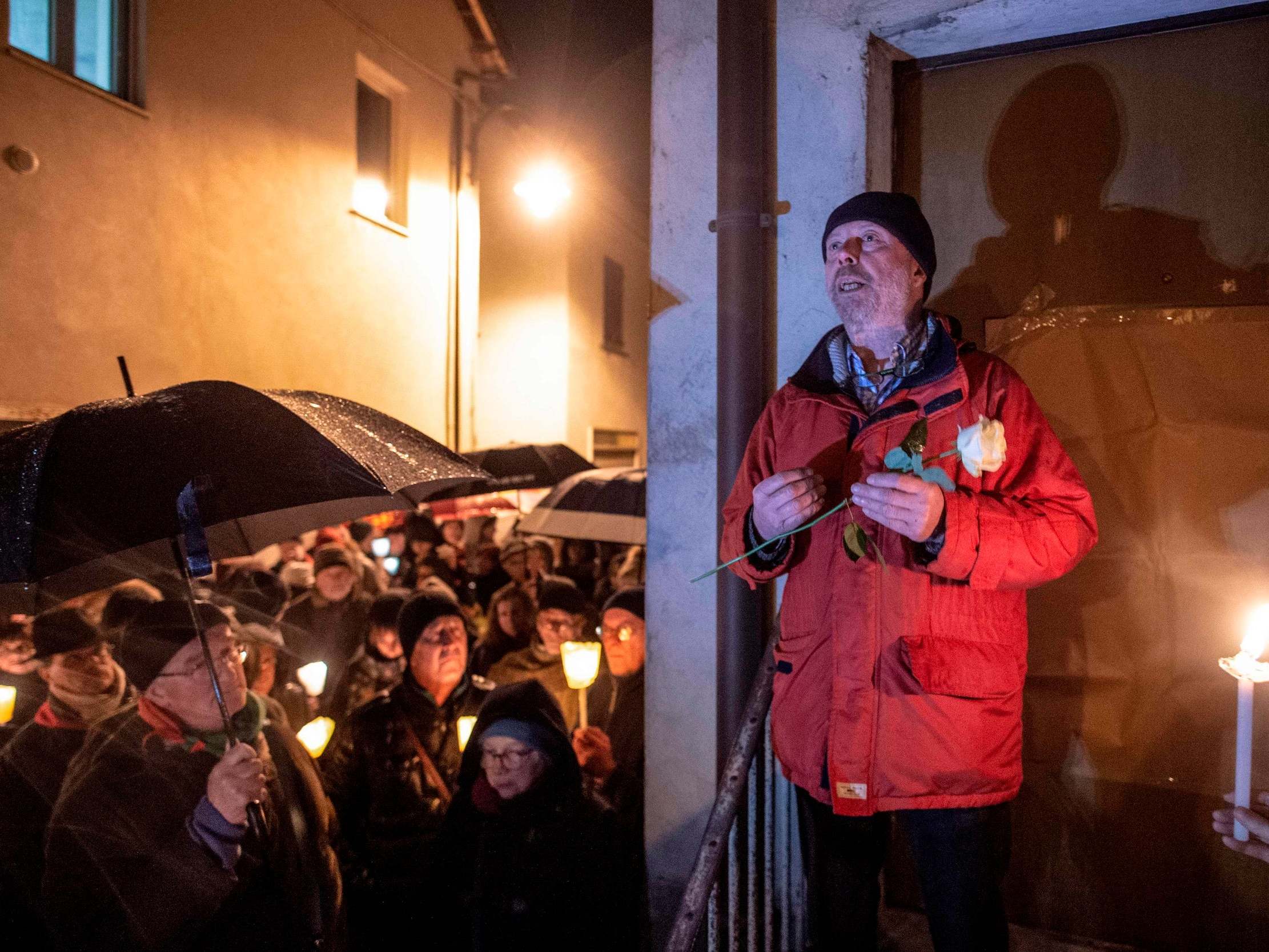 Aldo Rolfi speaks to participants of a demonstration against antisemitism