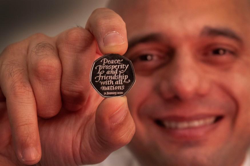 Sajid Javid displays the 50-pence coin commemorating Brexit