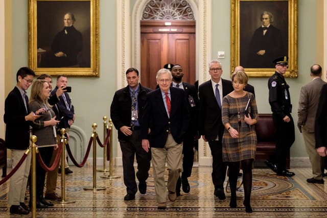 Mitch McConnell pictured walked to his office ahead of the hearing