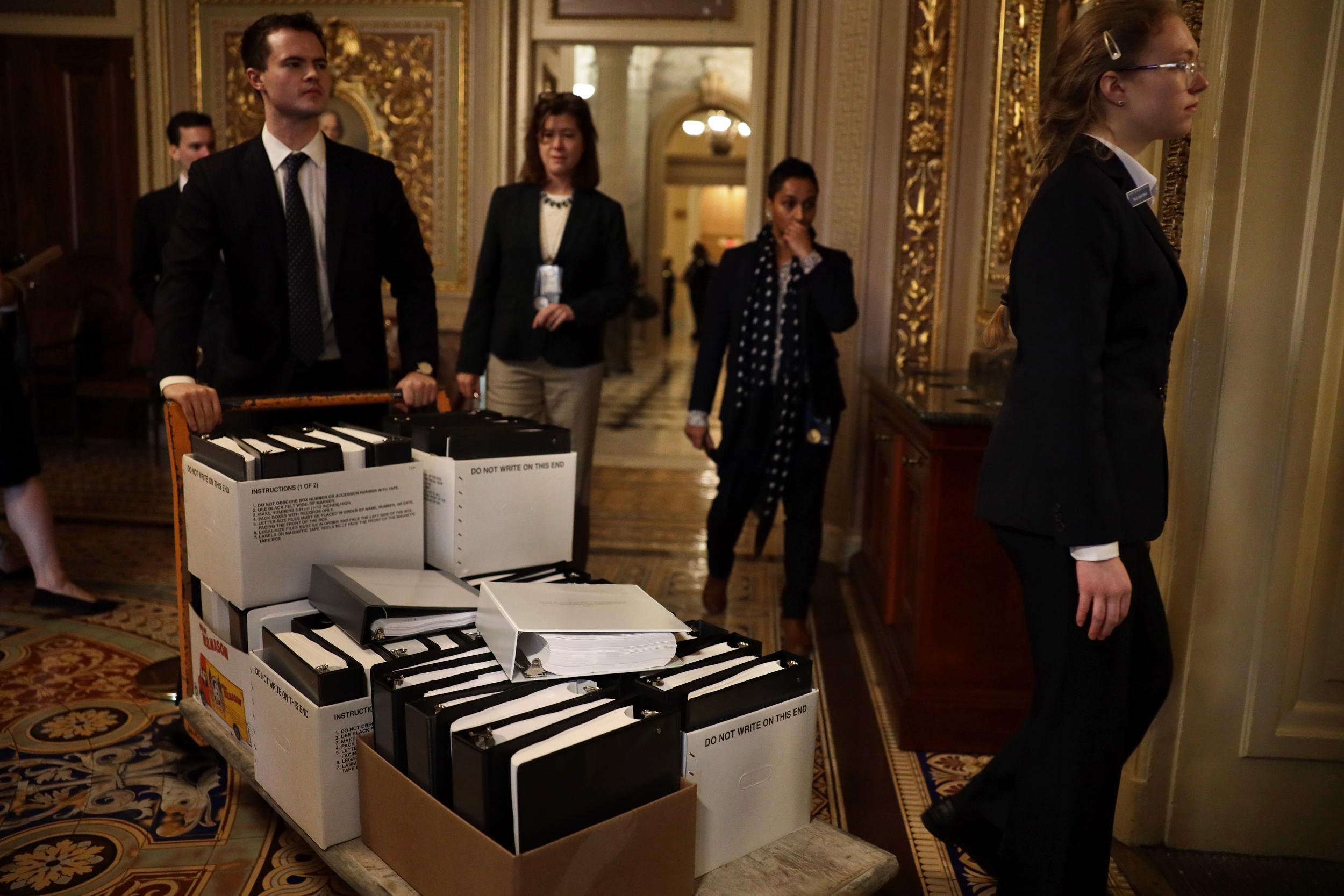 Stacks of legal papers are wheeled in ahead of the hearing