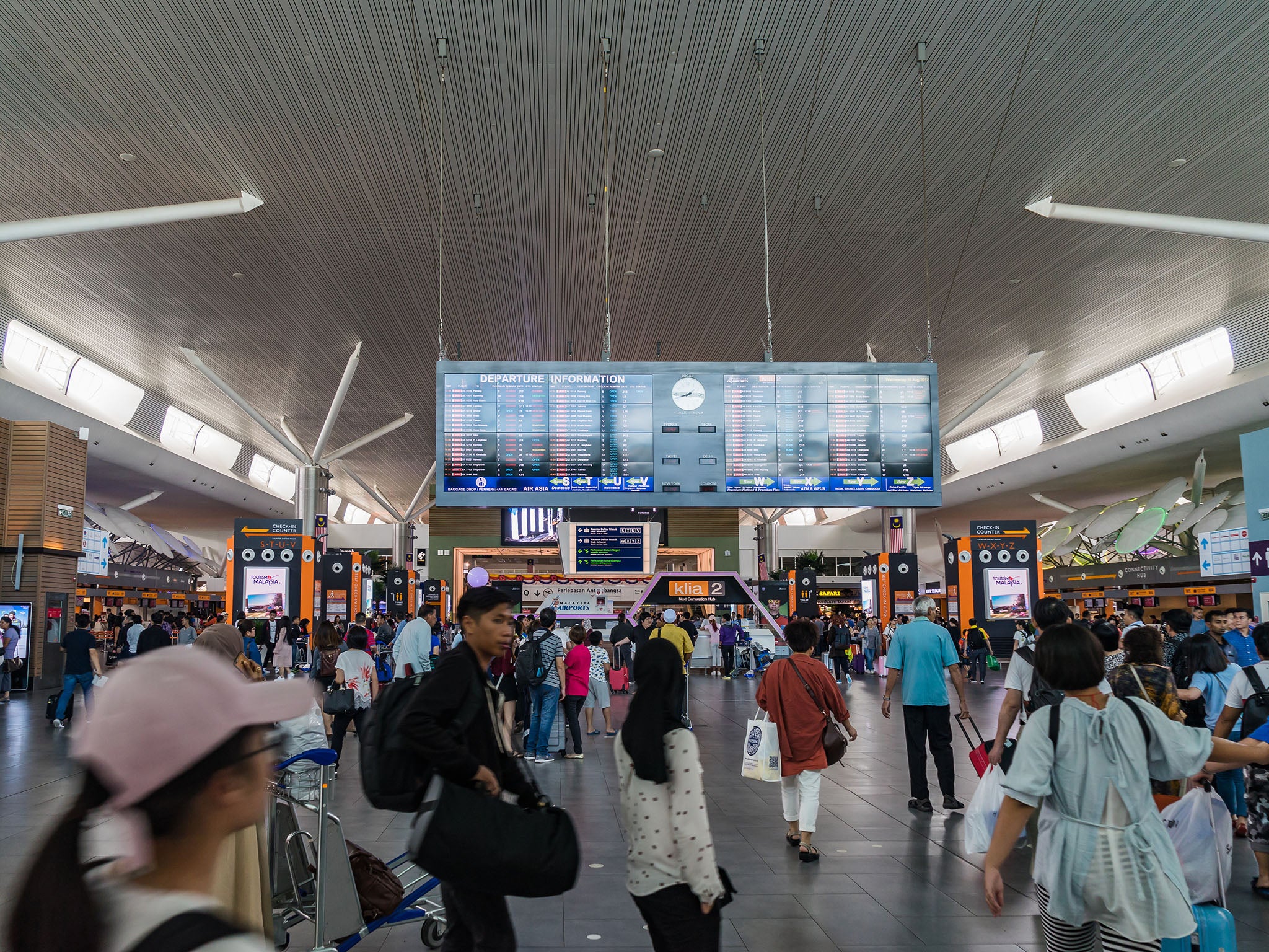 Are there grounds for a claim against Kuala Lumpur airport for its long passport queues?