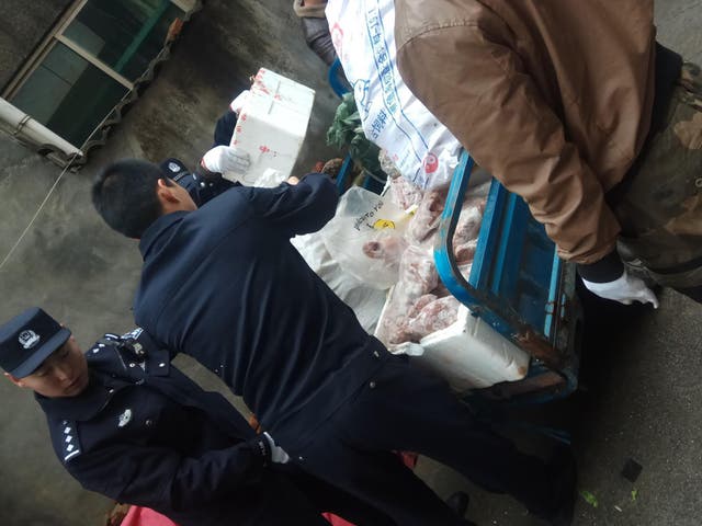 Police load a cart with items seized from a store suspected of selling trafficked wildlife are seen in Anji city in eastern China's Zhejiang province on Jan 17 2020