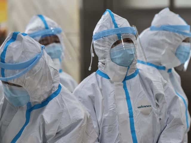 Medical staff members wearing protective clothing to help stop the spread of a deadly virus