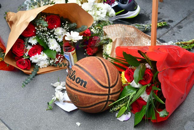 People gathered at a makeshift memorial in Los Angeles after news of the player's death broke