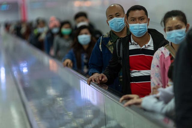 Commuters wear face masks in the Mass Transit Railway (MTR) in Hong Kong
