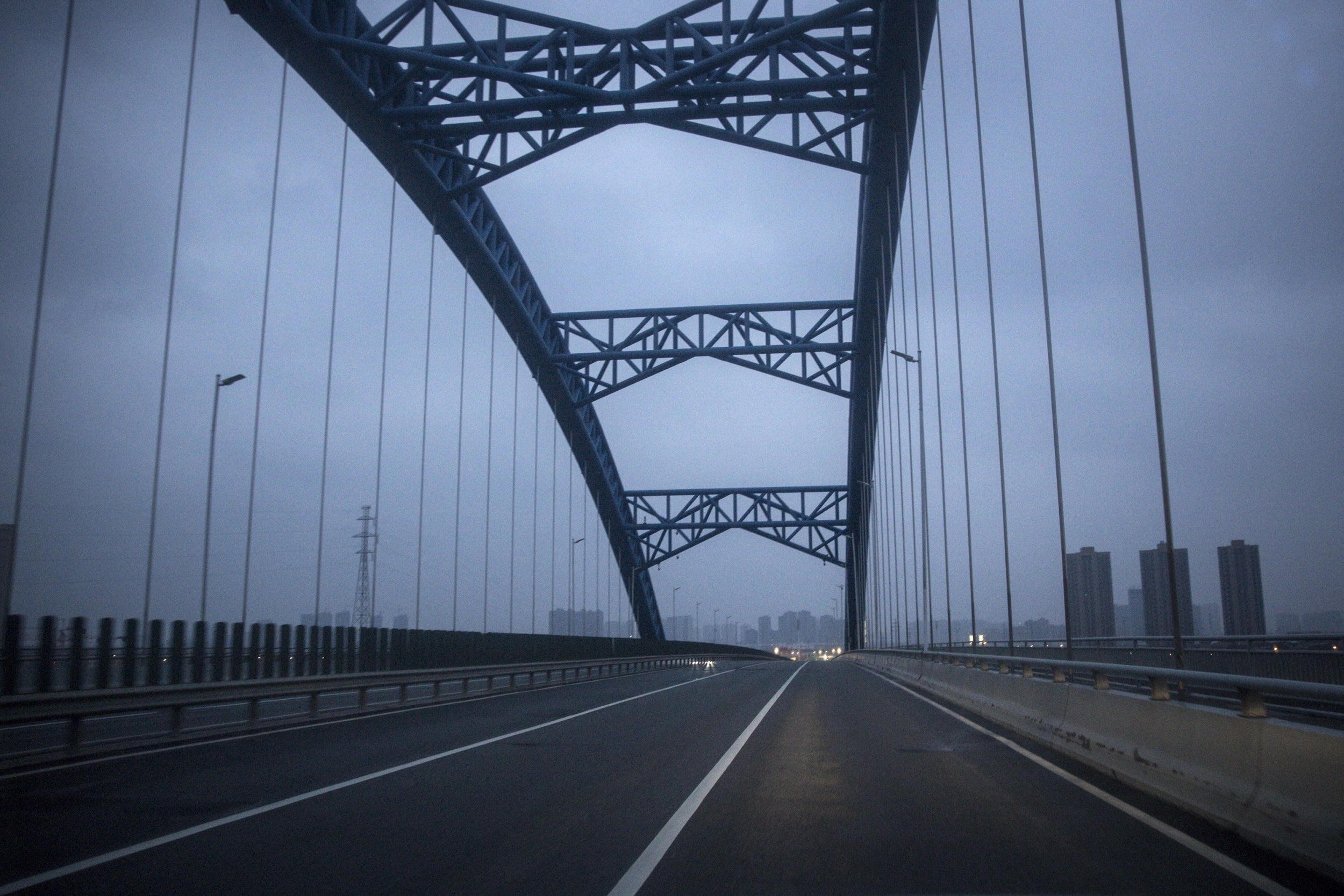 Roads in Wuhan lie empty after authorities imposed travel bans on the city and surrounding area