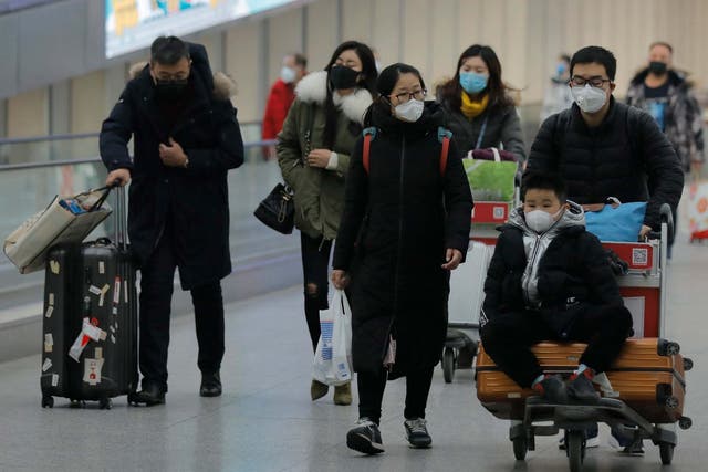 Passengers wearing masks are seen at terminal 3 of Beijing Capital International Airport in Beijing, China, 26 January 2020.