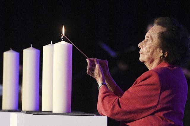 Holocaust survivor Lily Ebert lights a candle at a National Holocaust Memorial Day event in London 2017