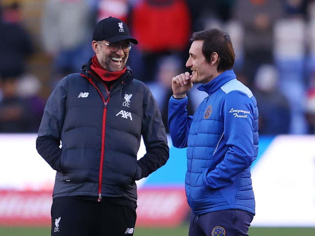 Jurgen Klopp speaks with Shrewsbury's Sam Ricketts before kick-off