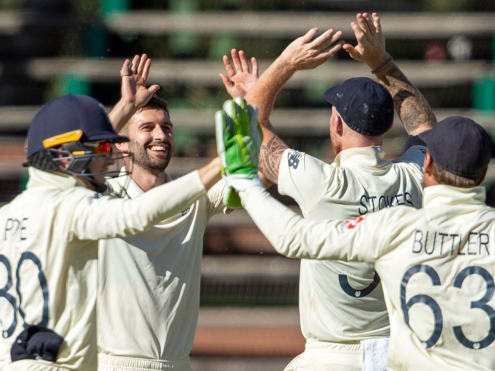 Mark Wood celebrates after taking the wicket of Quinton de Kock