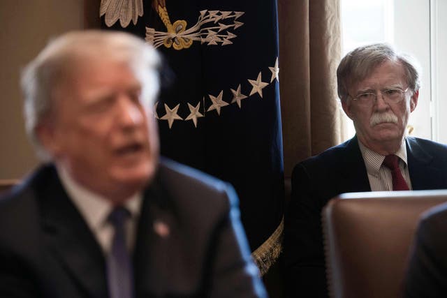 Former national security adviser John Bolton looks on as Donald Trump speaks at the White House. AFP via Getty Images