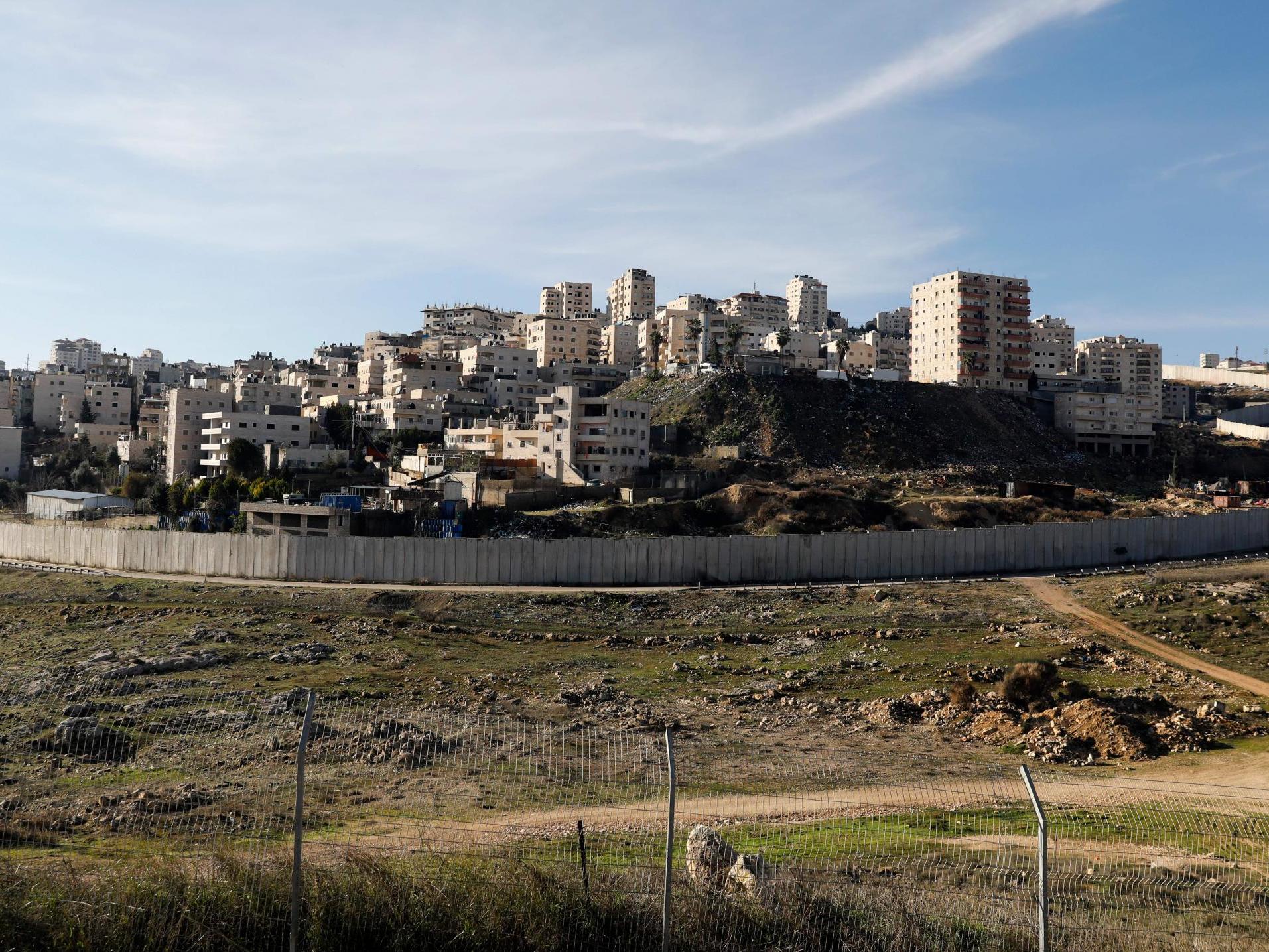 Israel's controversial separation wall in front of the Palestinian Shuafat refugee camp in the Israeli-annexed eastern sector of Jerusalem