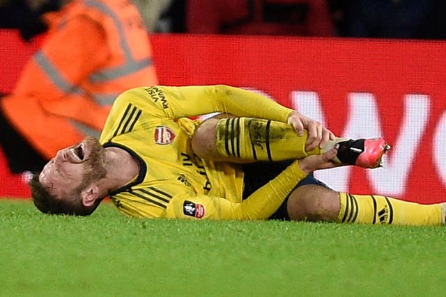 Shkodran Mustafi of Arsenal goes down injured