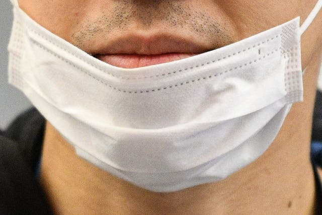 A traveller wears a face mask at an airport in Germany