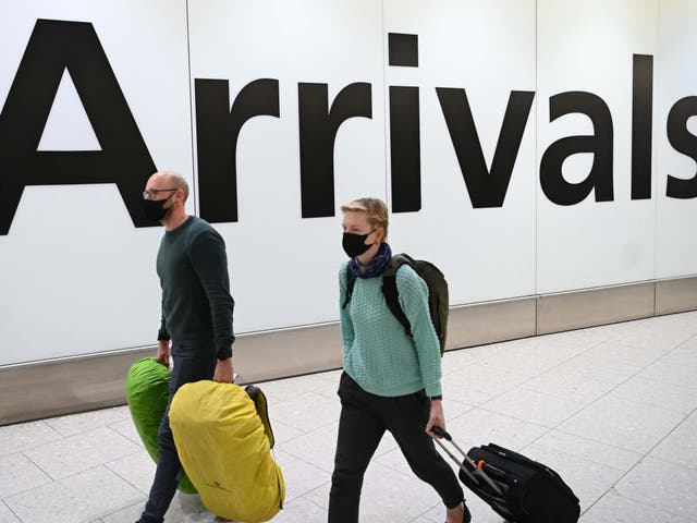 Passengers wear face masks as they arrive at London Heathrow Airport in west London on 28 January, 2020.