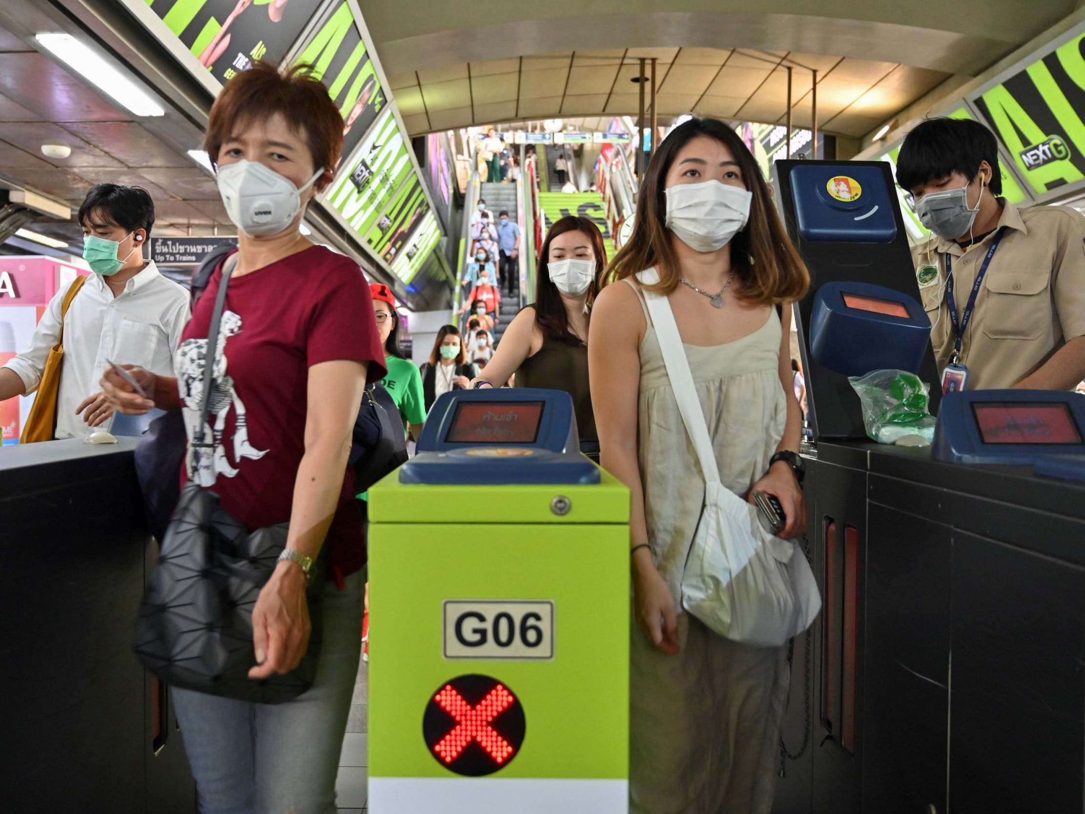 People wear protective facemasks at train station in Bangkok, Thailand, on Tuesday (AFP/Getty)