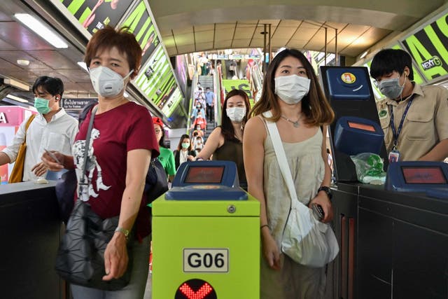 People wear protective facemasks at a commuter train station in Bangkok, Thailand, on 28 January, 2020.