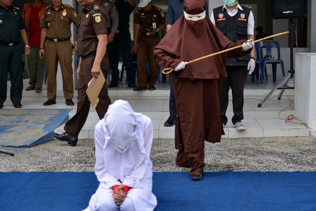 Indonesia's first female flogger prepares to whip a woman in public