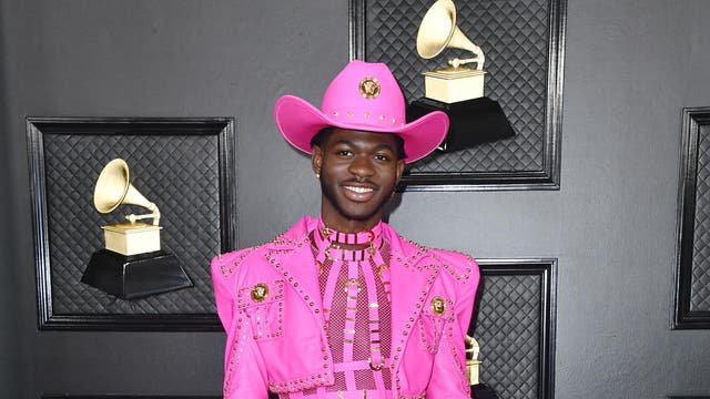 On the night he became a Grammy Award-winning artist, Lil Nas X made the red carpet his own in a hot pink custom-made Atelier Versace suit, complete with a matching cowboy hat in keeping with his signature style.