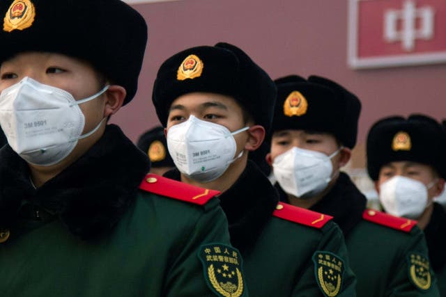 Chinese police officers wear facemasks to protect them from the spread of coronavirus