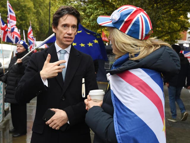 Rory Stewart talking to a demonstrator outside parliament in London, October 2019