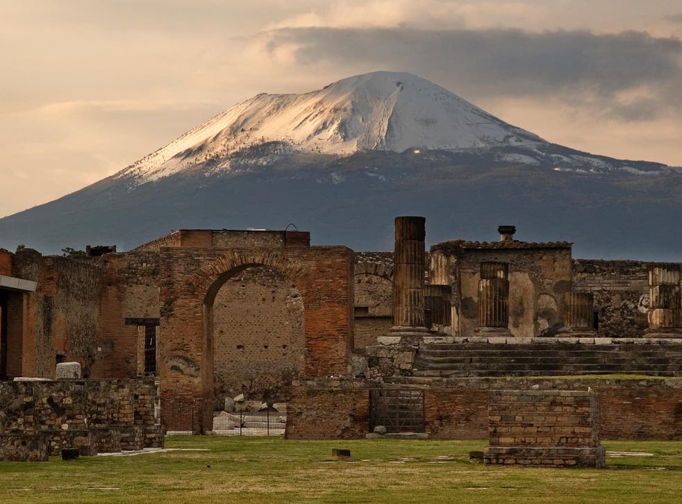 Mount Vesuvius looms over the Temple of Jupiter in the ancient city   