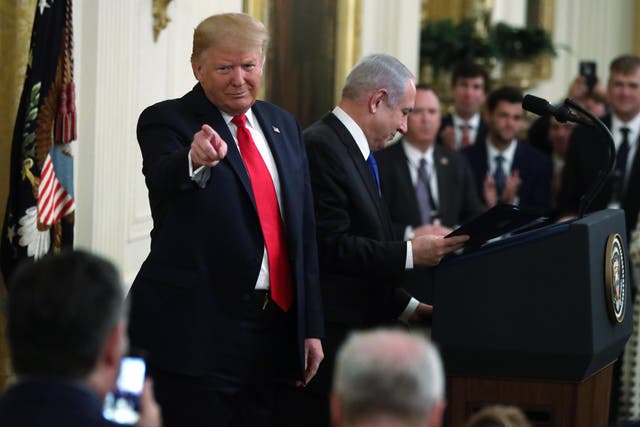 US President Donald Trump gestures during a press conference with Israeli Prime Minister Benjamin Netanyahu (C) in the East Room of the White House on January 28, 2020 in Washington, DC.