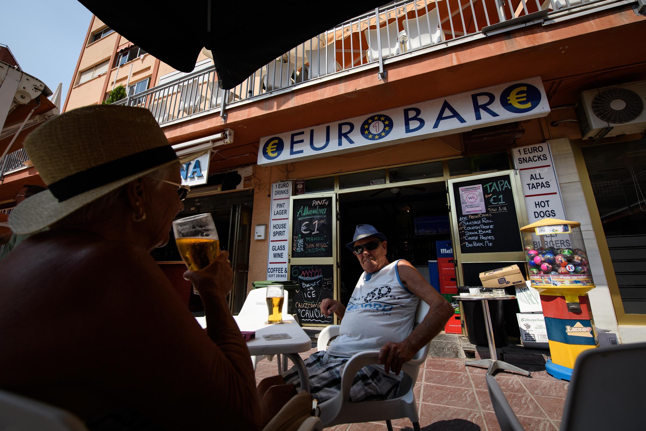 Customers enjoy the afternoon sun as they relax outside the EuroBar pub
