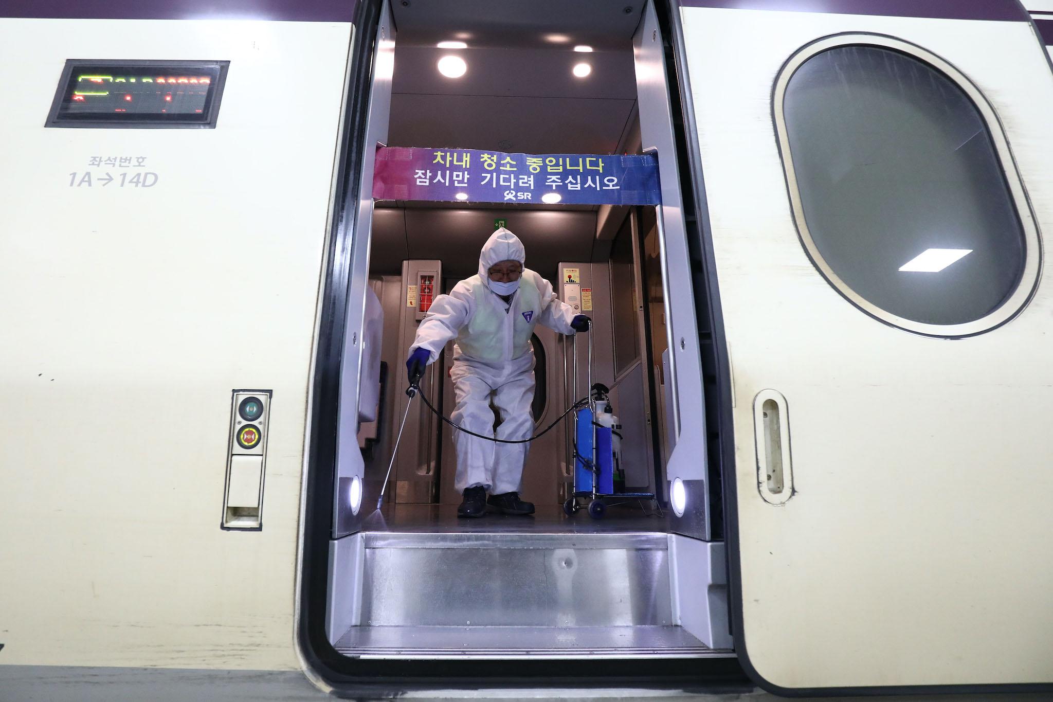 A disinfection worker wearing protective gears spray anti-septic solution in an train amid rising public concerns over the spread of China's Wuhan Coronavirus at SRT train station on January 24, 2020 in Seoul, South Korea